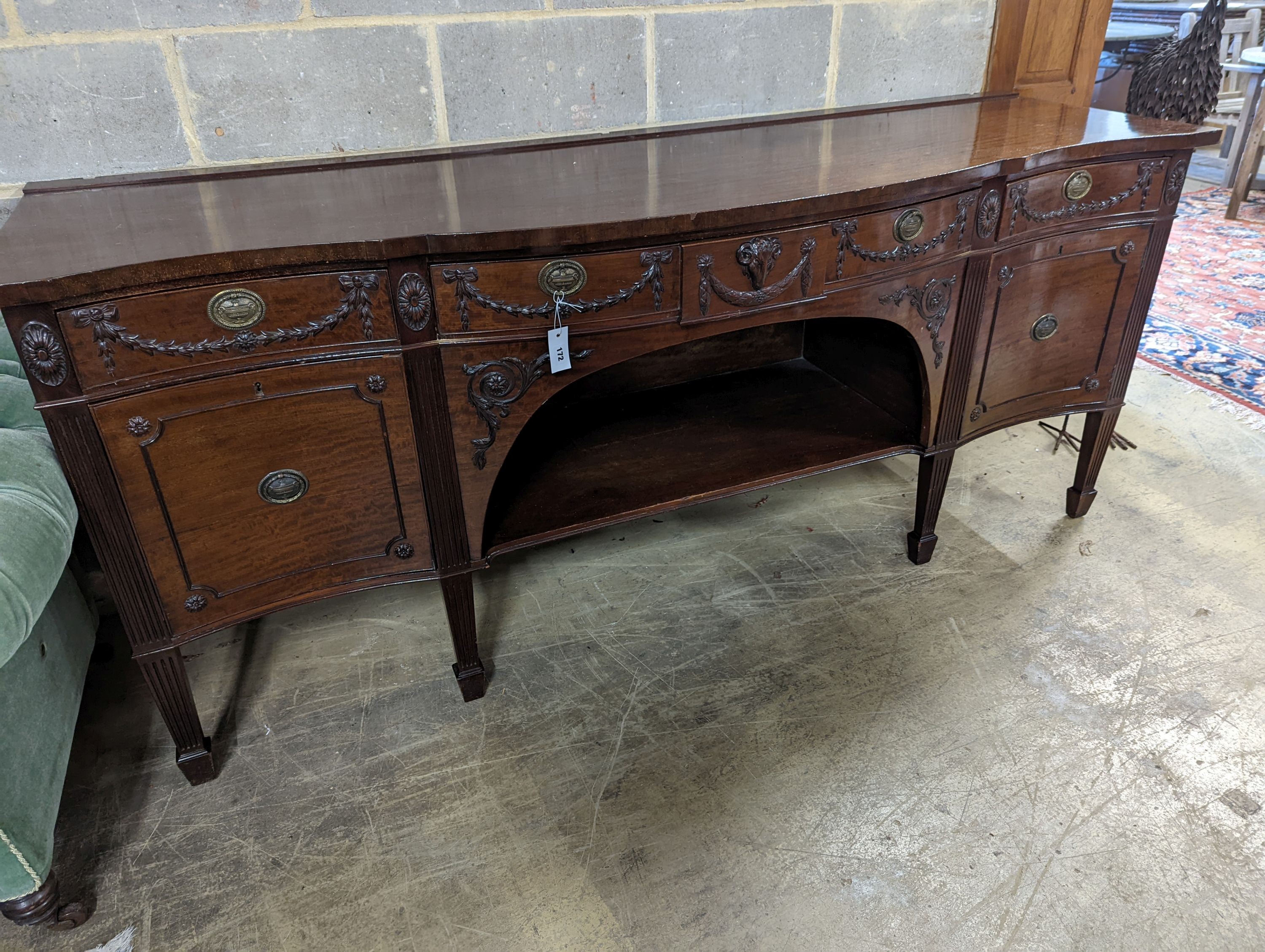 An early 20th century Adam design mahogany serpentine sideboard, length 214cm, depth 68cm, height 92cm